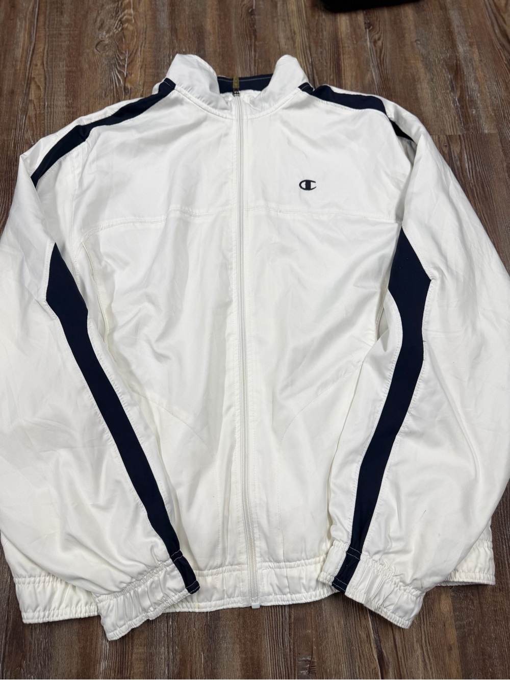 Vintage Champion white windbreaker jacket with navy blue stripes on sleeves and
